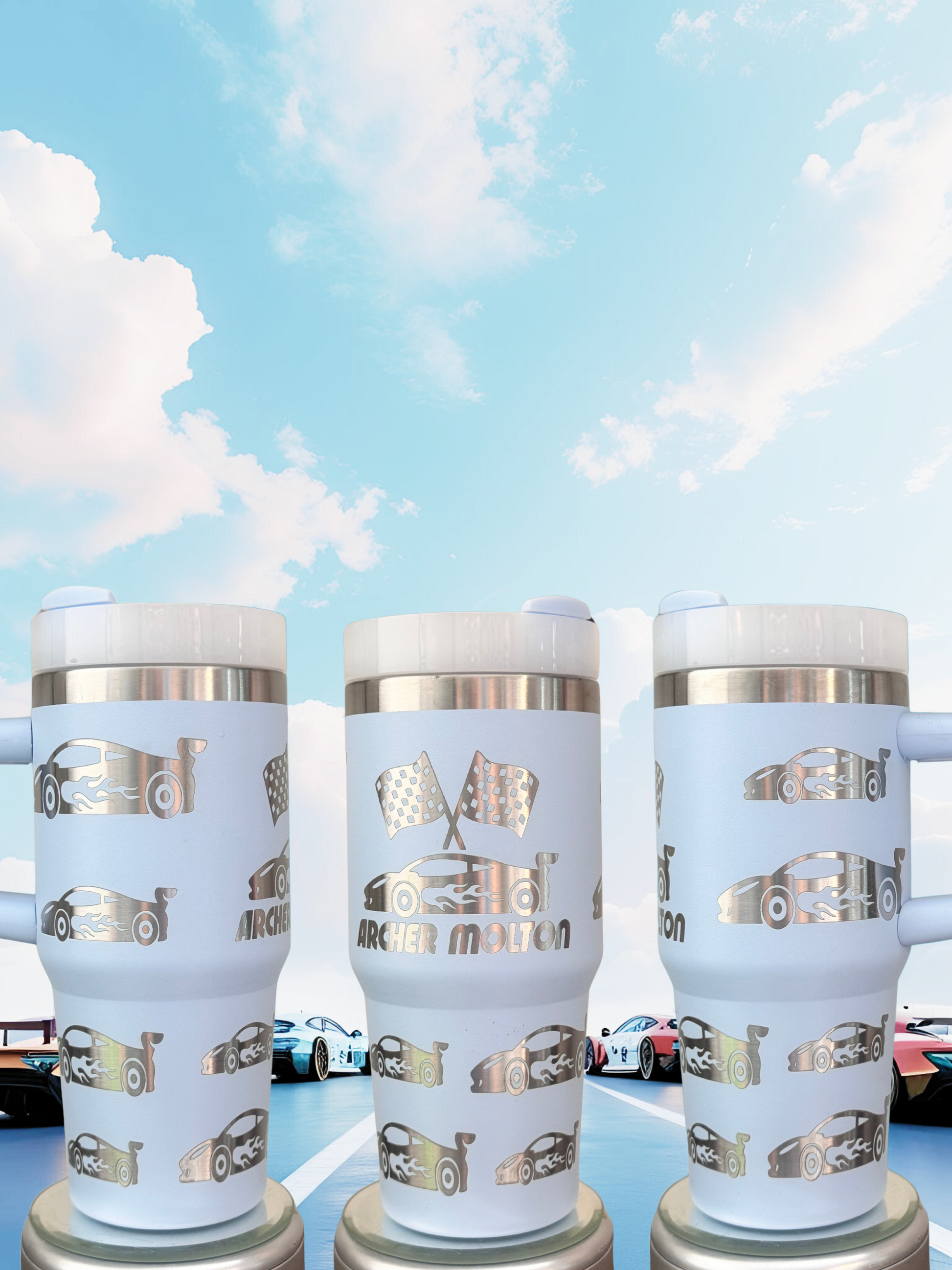 Three white tumblers with silver designs featuring racing cars on a blue background.